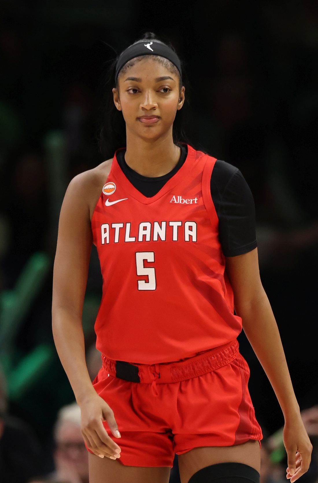 Angel Reese on court in a red Atlanta Dream number 5 jersey