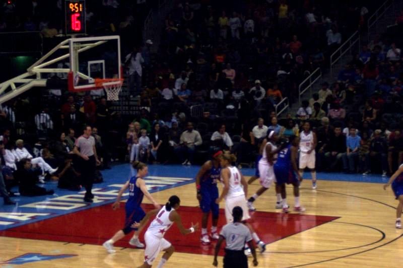 Dream players in white uniforms on court during a 2008 home game