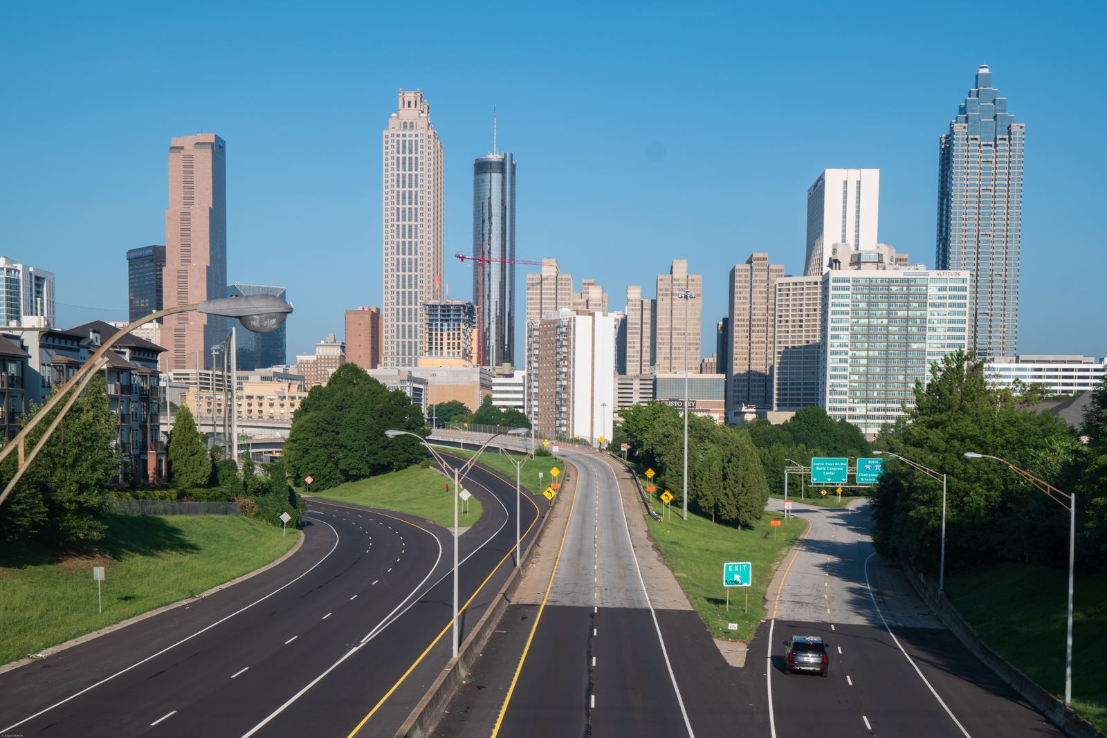 Downtown Atlanta skyscrapers rising beyond Freedom Parkway, seen from the Jackson Street Bridge on a clear day
