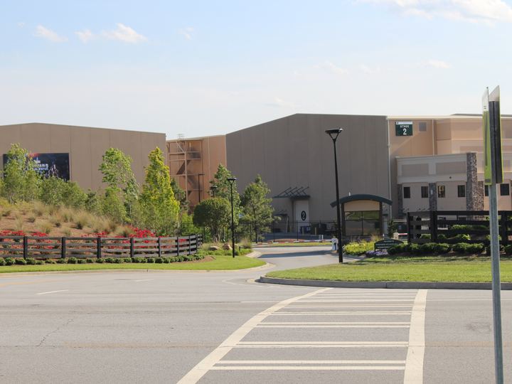 Large soundstage buildings behind a landscaped entrance at the Fayetteville studio campus south of Atlanta