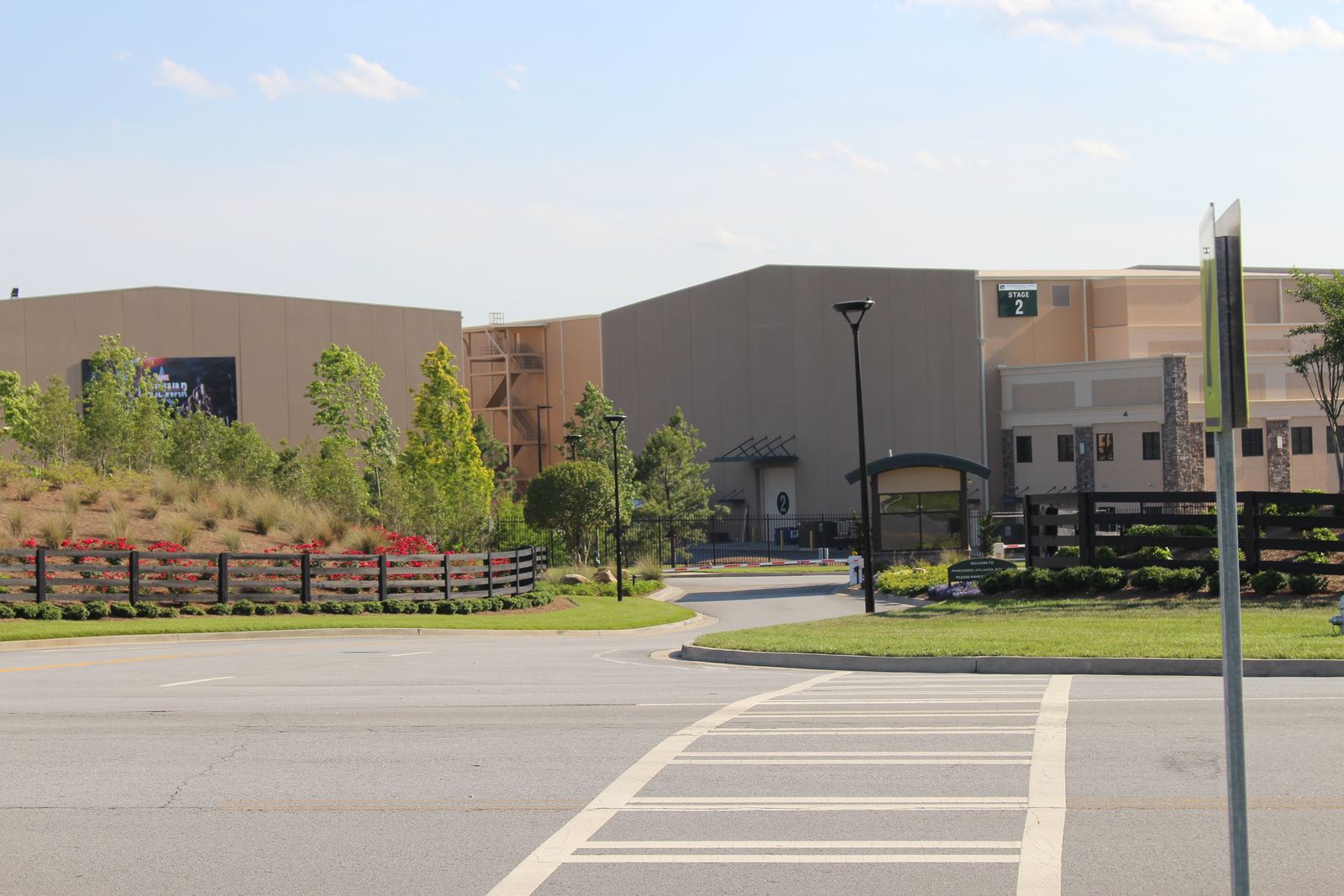 Large soundstage buildings behind a landscaped entrance at the Fayetteville studio campus south of Atlanta