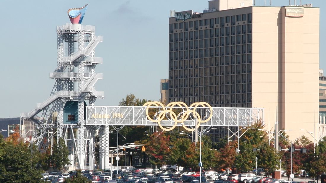 The steel 1996 Olympic cauldron tower and an Olympic rings bridge near the old stadium