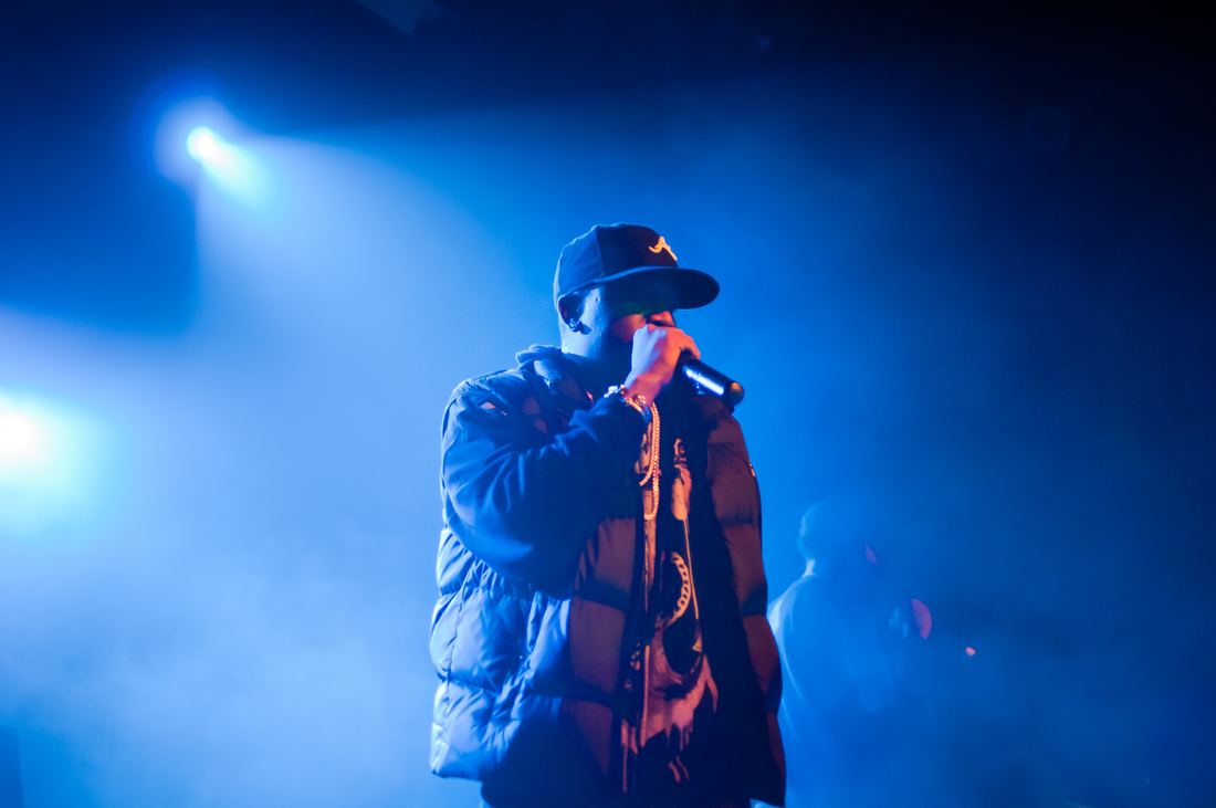 Big Boi rapping on a blue-lit stage