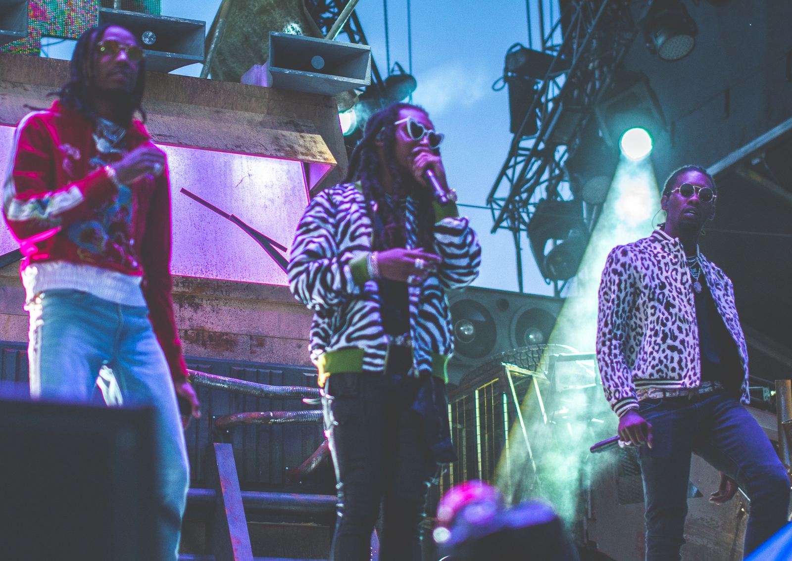 Quavo, Takeoff and Offset of Migos performing together on an outdoor festival stage