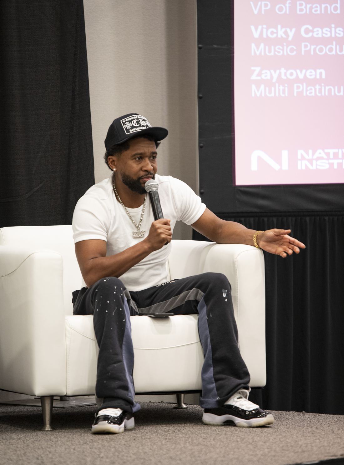 Producer Zaytoven speaking on a panel stage at SXSW
